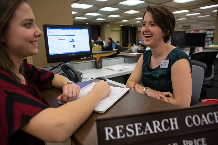 Student getting research help from a librarian