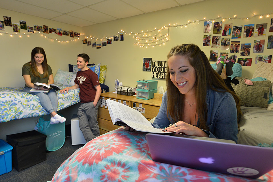 Students spend time in a dorm room.