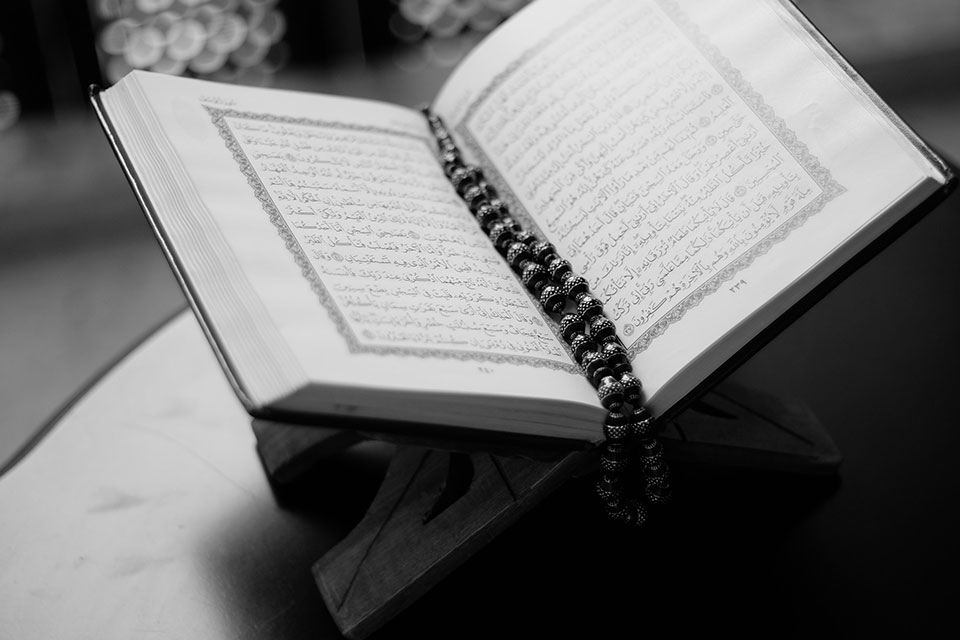 A picture of the Quran open on a table.