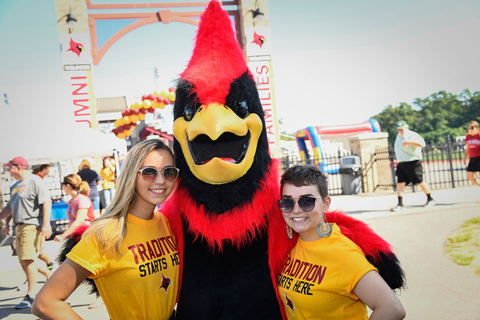 Students pose with the Cardinal.