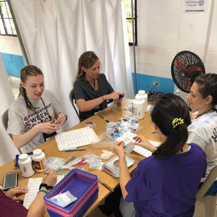 Students from the Wegmans School of Pharmacy work at a clinic in El Salvador.