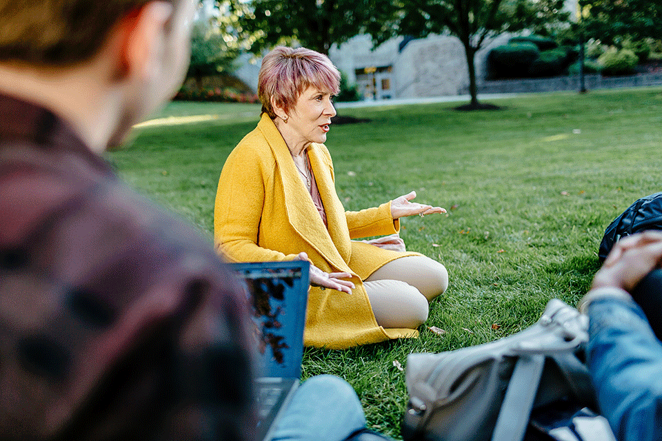Dr. Carolyn Vacca teaches a class outside on the quad.
