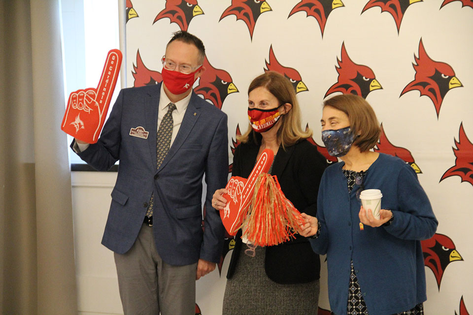 Fisher staff members celebrate the launch of the giving campaign with the help of Cardinal.