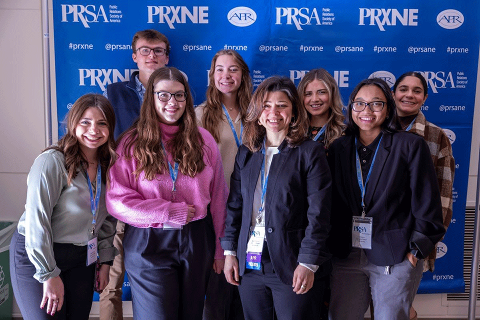 Professor Arien Rozelle with Fisher students at the 2023 PRxNE District Conference.