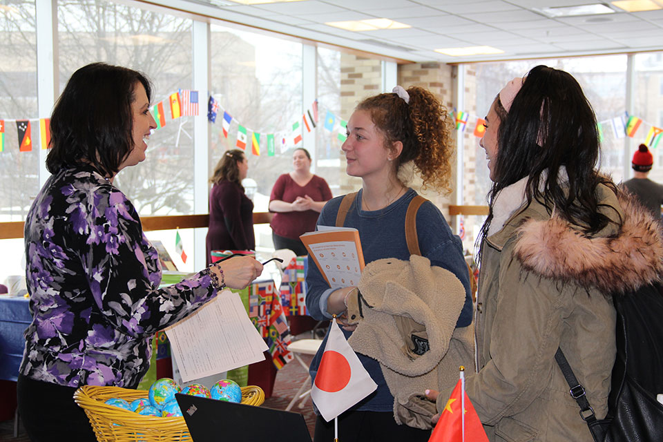 Jen Pluretti with the Center for Career and Academic Planning talks with two students about study abroad opportunities at Fisher.