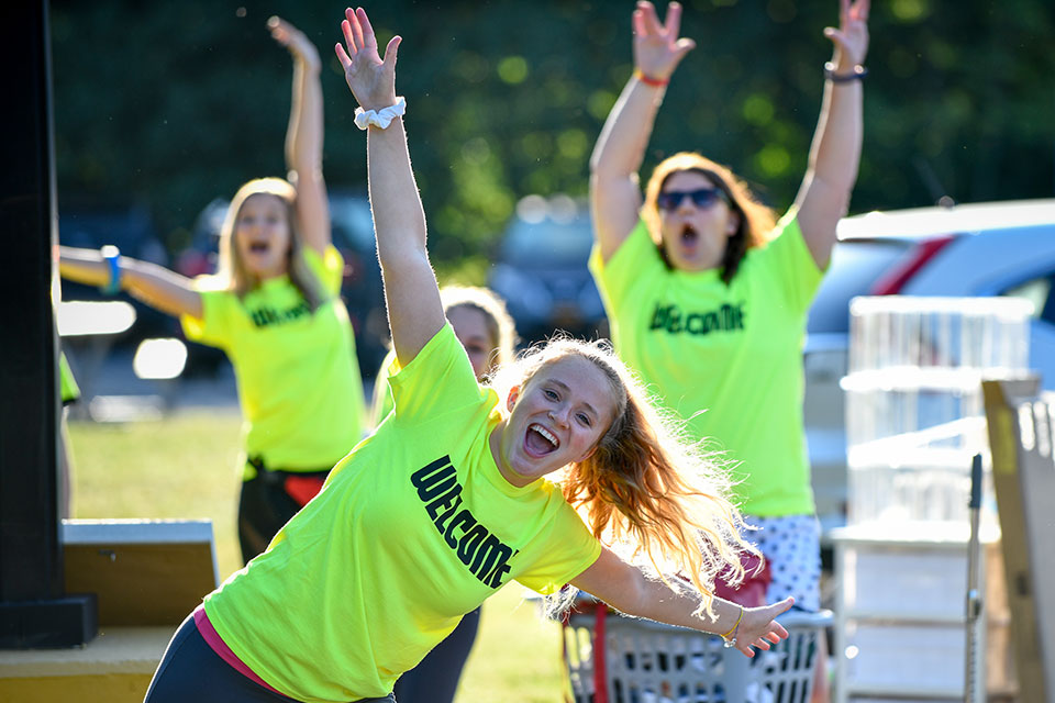 Hannah Batten raises her arms in excitement during Move In Day.