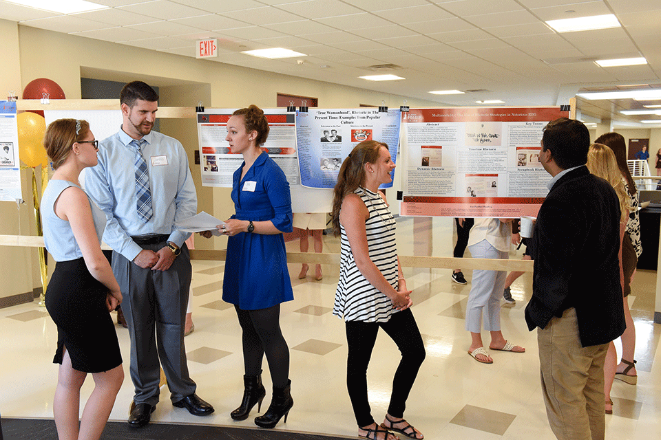 Students and faculty talk at the Center for Student Research and Creative Work research symposium.