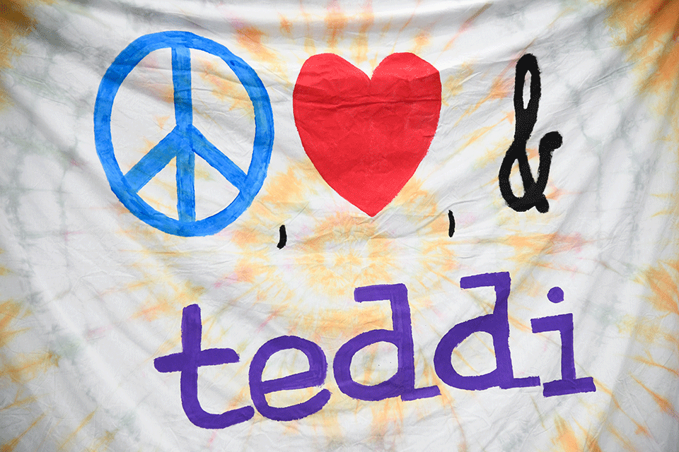 A banner reads Peace, Love, Teddi.
