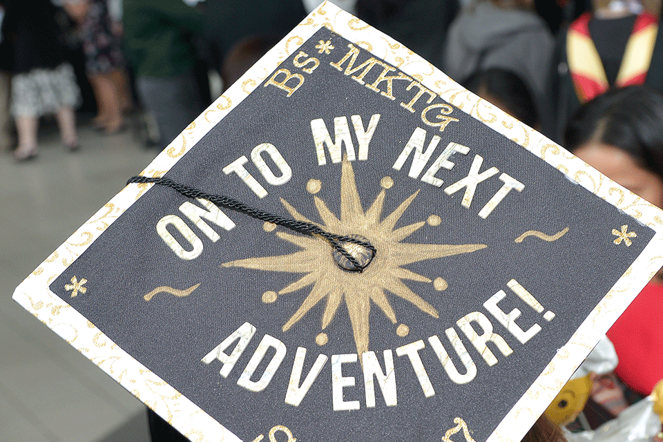 A decorated mortar board reads, On to my next adventure.
