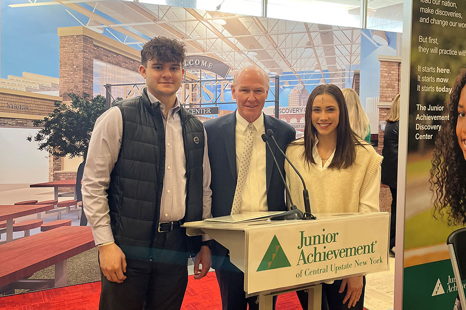President Rooney (center) with two Fisher students at the announcement of the Region’s First Junior Achievement “Discovery Center.” 
