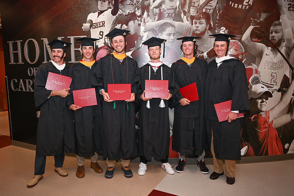 Student-athletes pose with their diplomas after the special Student-Athlete Commencement Ceremony.
