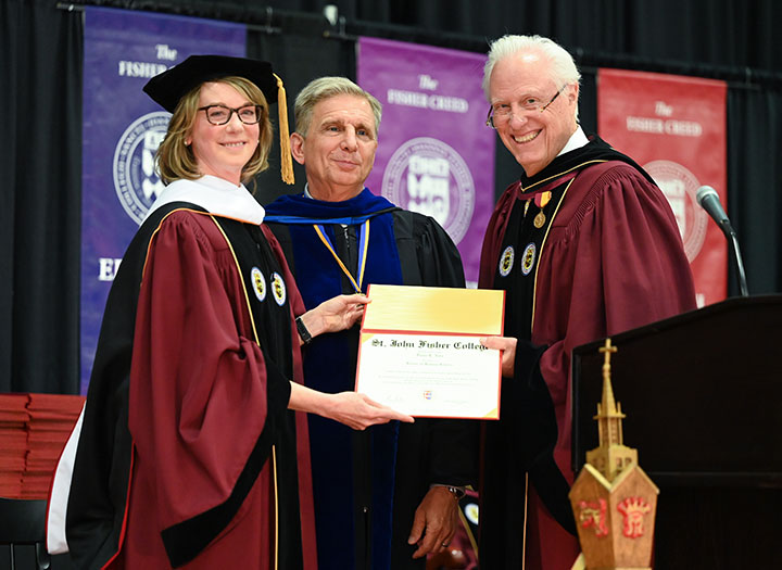 Provost Kevin Railey and Incoming Board Chair Tom Bowles present Diana Nole (left) with an honorary degree.