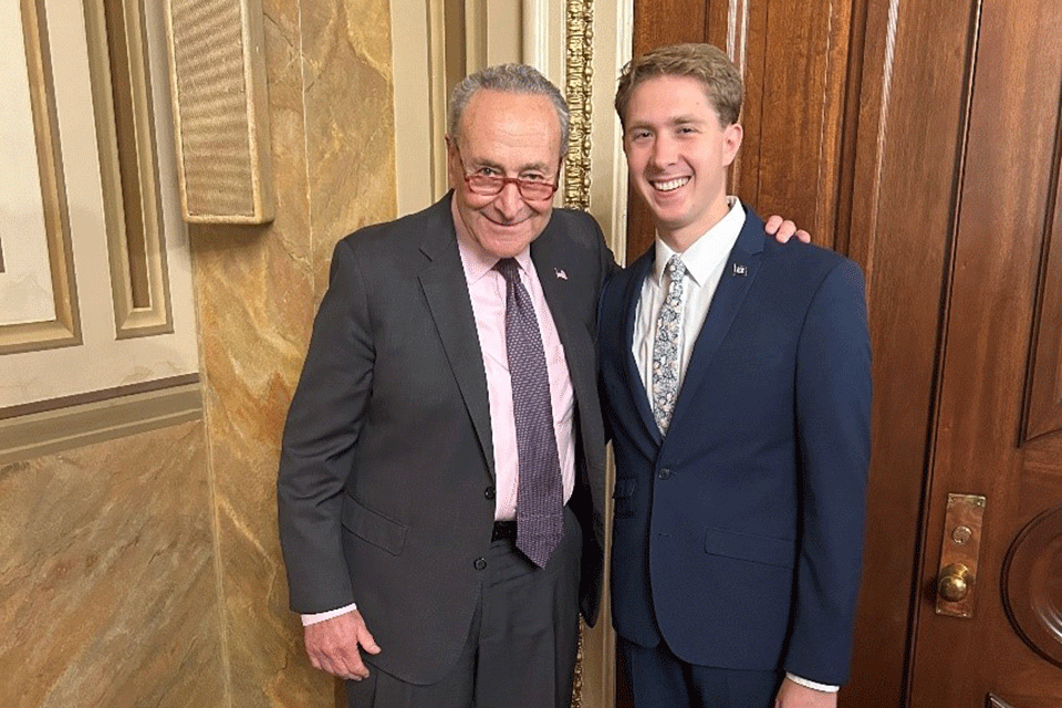 Fisher student Ian Klenk (right) with Senate Majority Leader Chuck Schumer.