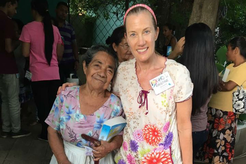 Kristine Schwandt poses with a community member while on a medical mission trip.