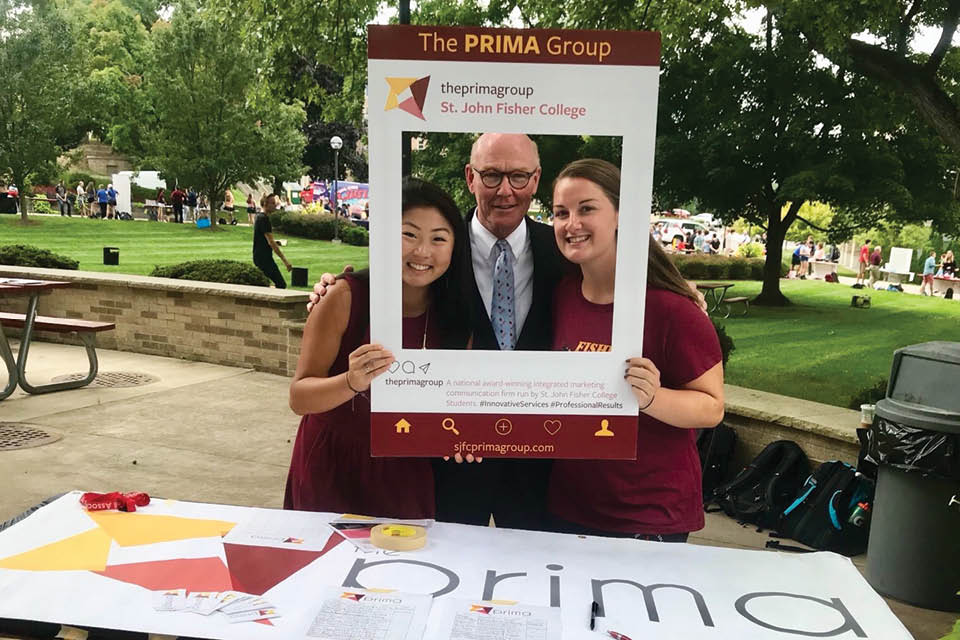 President Rooney with two PRIMA students