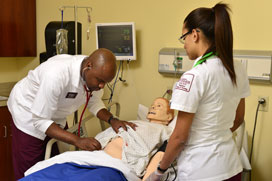 Students work as a team to take vitals and assess their patient.