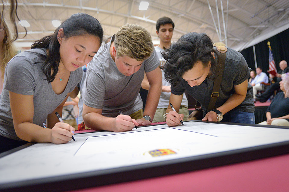 Students sign the Fisher Creed during the annual Matriculation Ceremony, part of Orientation Weekend.