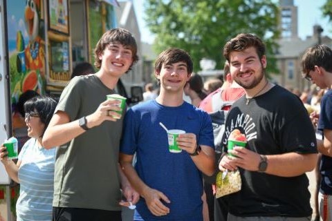 Students enjoy treats from food trucks on campus during Welcome Weekend.